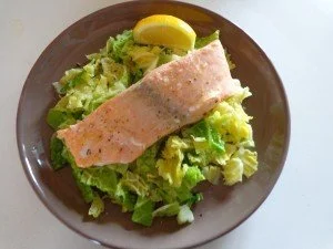 Saumon cuit à la vapeur sur un nid de chou, plat sain et délicieux.